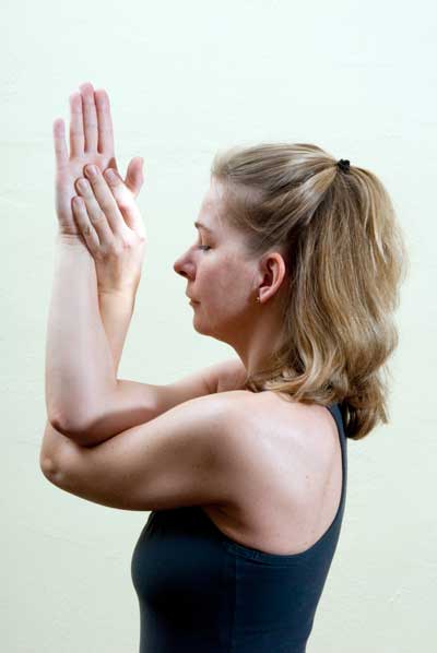 Hands at heart-center in yoga mudra